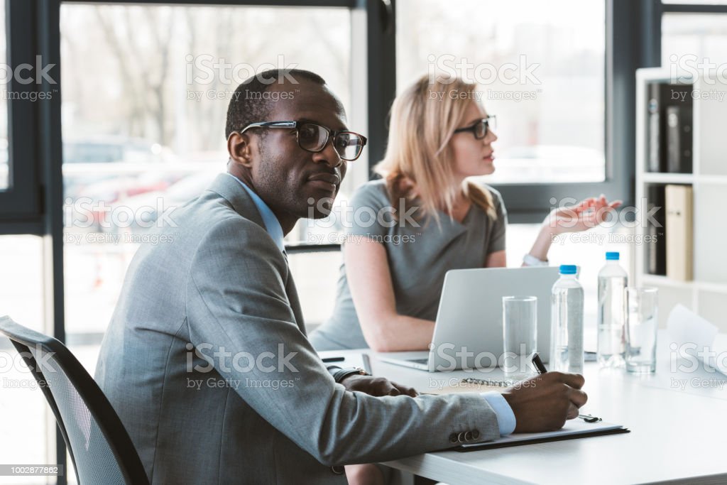 multiethnic businessman and businesswoman working at business meeting in office